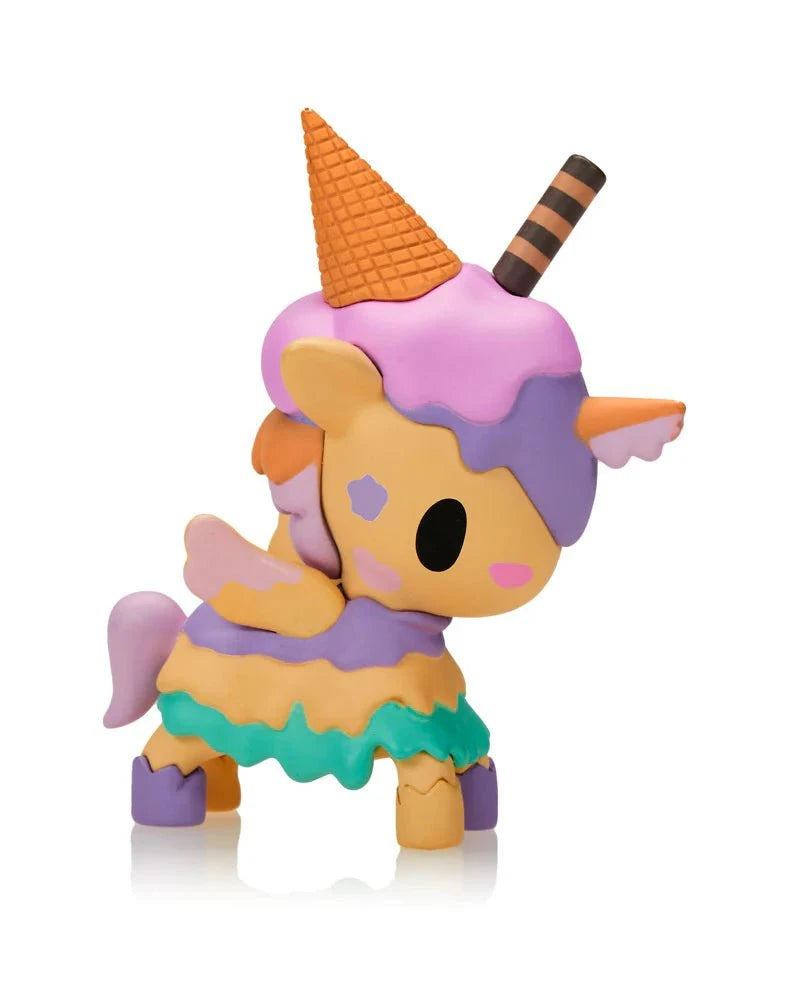 The Tokidoki Ice Cream Shop Unicorno Blind Box features a cute, pastel Unicornos figurine with an orange ice cream cone hat, chocolate stick, and ruffled skirt, shown on a white background.