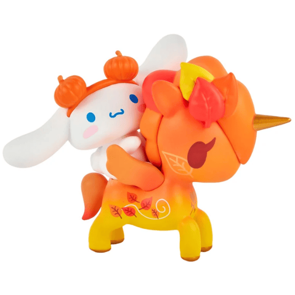 A cute white cartoon character with orange buns rides an orange unicorn with autumn leaves and a gold horn in this adorable tokidoki Tokidoki x Hello Kitty and Friends Pumpkin Spice Cinnamoroll & Autumn Special Edition.