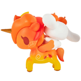 A whimsical collaboration between tokidoki and Hello Kitty and Friends, the Pumpkin Spice Cinnamoroll & Autumn Special Edition features a cute, cartoon-style orange and yellow unicorn figurine adorned with leaf and swirl designs, carrying a white bunny figure decorated with pumpkin accents. This delightful collectible captures the playful charm of both brands in a special tokidoki release.