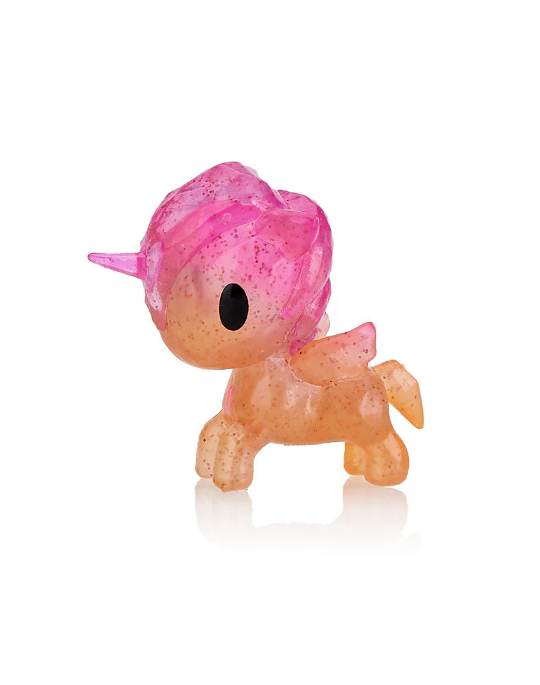 The Tokidoki Unicorno Capsule Cuties Pink Dusk Special Edition is a collectible figurine showcasing a unicorn with a pink mane and horn, along with an orange body, as part of the enchanting series. Set against a white background, it beautifully captures the magic of a pink dusk.