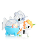 Two vibrant Unicorno Capsule Cuties figures: one featuring an orange mane and a green horn, and the other showcasing transparent details with a blue body. Ideal for tokidoki's Unicorno Blind Box enthusiasts or collectors of Capsule Cuties from Tokidoki.