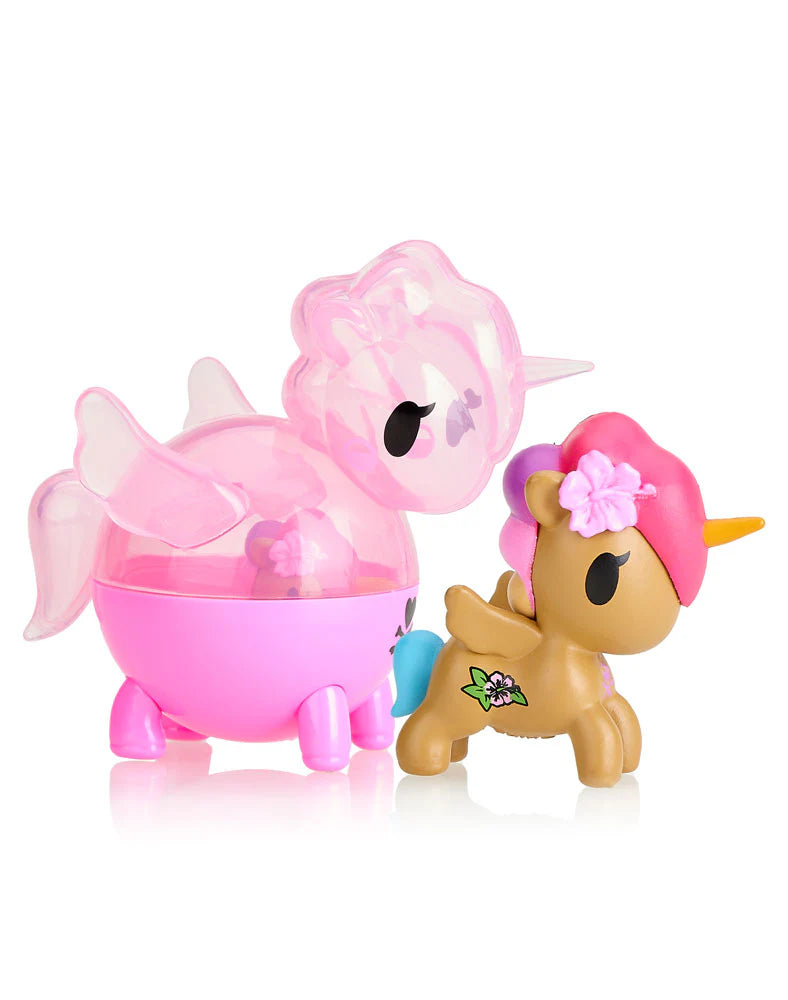 Two vibrant toy figures: a pink, translucent creature with wings capturing the playful spirit of Tokidoki's Unicorno Capsule Cuties Blind Box, and a brown unicorn with a pink mane and flower accessory, echoing the enchanting surprises associated with tokidoki products.