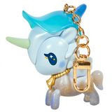 Here’s a rewritten sentence using the provided product data: The tokidoki Forest Fairy Calla Lily Special Edition Unicorno Keychain features a blue gradient mane, gold horn, gold collar, and sparkly legs. Adorned with a star and moon design near its eye and finished with a gold keychain clip on its neck, this enchanting accessory is perfect for fans of fairy-inspired designs.