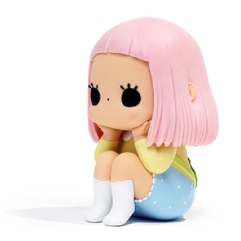 A small, stylized figure with pink hair, wearing a yellow top, blue polka-dotted pants, and white boots, sits with its chin resting on its hands. This is the Day Dreamer — Mr. Frog by How2Work (HK).