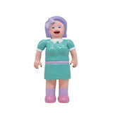 The Paradise Toy About Animals Michiko/Dinosaur — Series 3 features a plastic doll with purple hair, polka-dot bow, teal dress, and pink shoes standing next to a cute dinosaur plush against a white background.