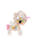 Explore the delightful Toki Mochi Donut Unicorno Blind Bag by Tokidoki—a compact, see-through toy unicorn brimming with vibrant sprinkles and embellished with pink details on the horn and tail. Ideal for surprise enthusiasts, it captures the whimsical essence of a blind box gem.