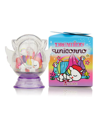 A colorful tokidoki Tokidoki Dreaming Unicorno Blind Box figure is displayed next to its bright packaging box featuring cute, dreamy unicorn-themed graphics, ready to take you on a magical adventure.