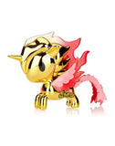 The Tokidoki Lucky Unicorno Fuego Limited Edition, featuring a gold finish with pink wings and a flowing mane, stands elegantly on a reflective surface, embodying fortune and grace.