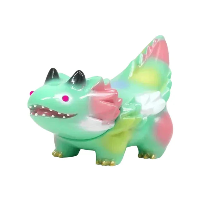 Seedlas Brother — Green Dots by The Little Hut (HK) is a small, colorful Kaiju dinosaur toy with green, pink, and yellow spots, white wings, black horns, and gold-tipped feet—ideal for any Seedlas Brother collection.