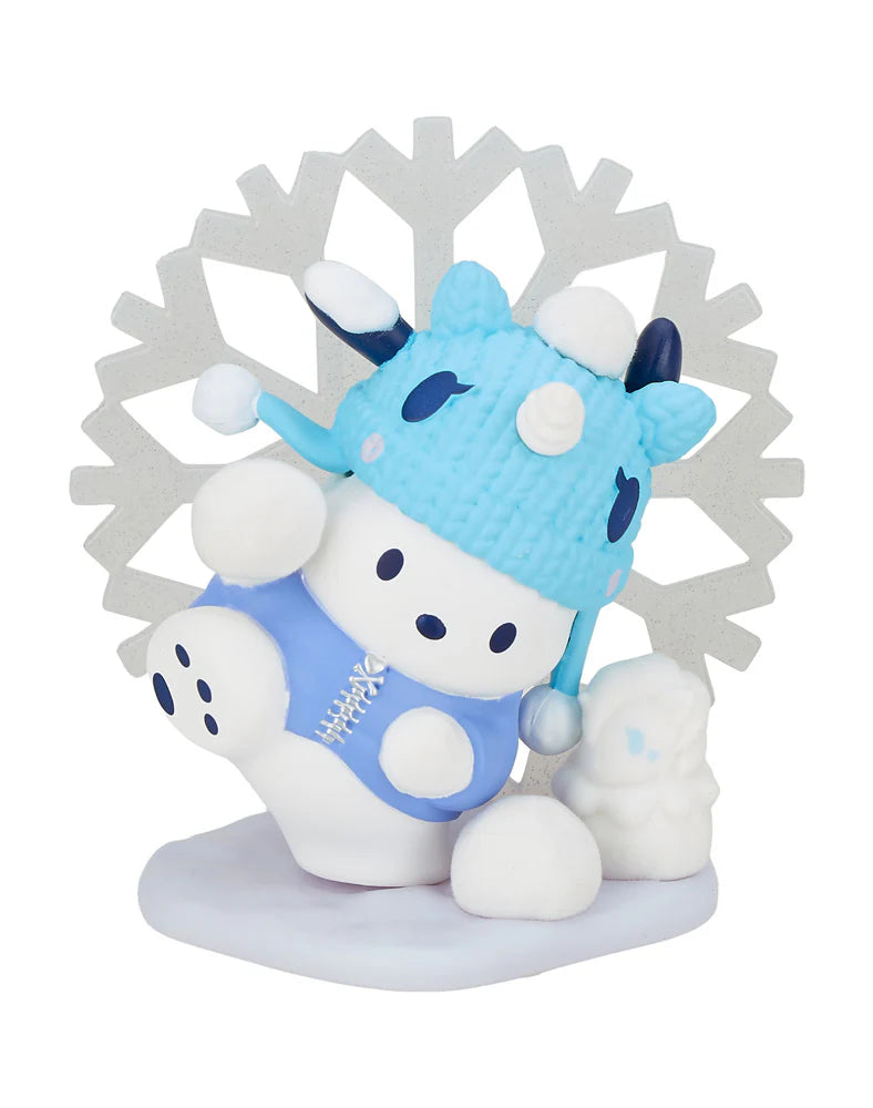 Dressed in a blue hat and outfit, the adorable cow figurine channels tokidoki's style as it sits with a small white animal against a large snowflake backdrop, perfectly embodying the spirit of the tokidoki x Hello Kitty and Friends Winter Dreams Blind Box.