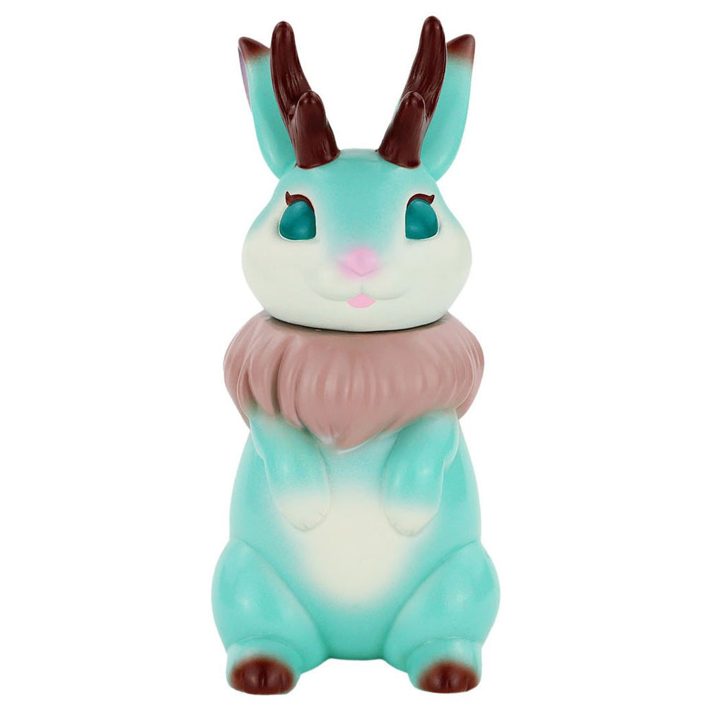 The Jackaron — Mint Chocolate by Konatsuya (JP) is a mint-green jackalope figurine with brown antlers, a pink nose, and a fluffy chocolate ruff, sitting upright like a playful Pokémon sofubi.