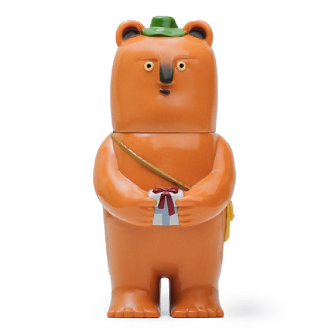 A cartoon bear figure with a green hat and a small bag across its body, holding a white gift box with a red ribbon, called "Kurichan — Original" from Paradise Toy (TW).