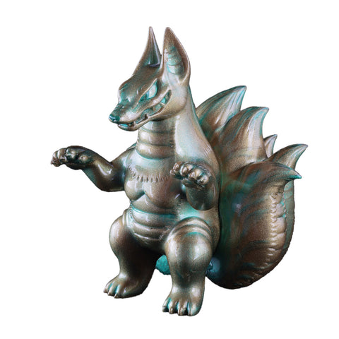 A Kyubiros figurine, crafted by Konatsuya (JP), features a metallic reptilian creature with prominent dorsal spikes, standing on its hind legs with its forearms raised.