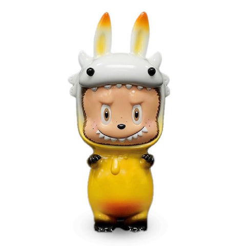 A small figurine of Byron Labubu by How2Work (HK) in a yellow costume with a white animal head hood and small outstretched arms. The hood has long ears and the character has a slightly grumpy expression.