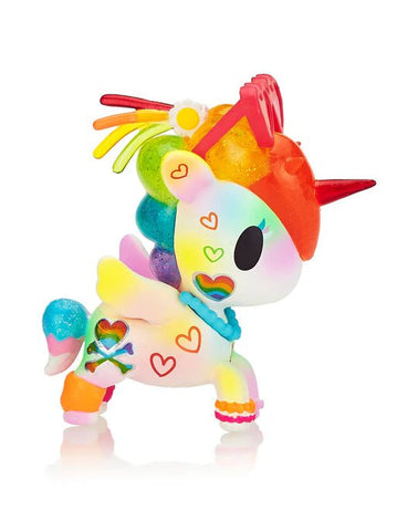 A colorful unicorn figurine adorned with rainbow patterns, hearts, and a flower on its head. It has a red horn and various bright-colored elements throughout its body, accented with sparkles that catch the light beautifully — the Tokidoki - Pride Lulu Special Edition Figure by tokidoki.