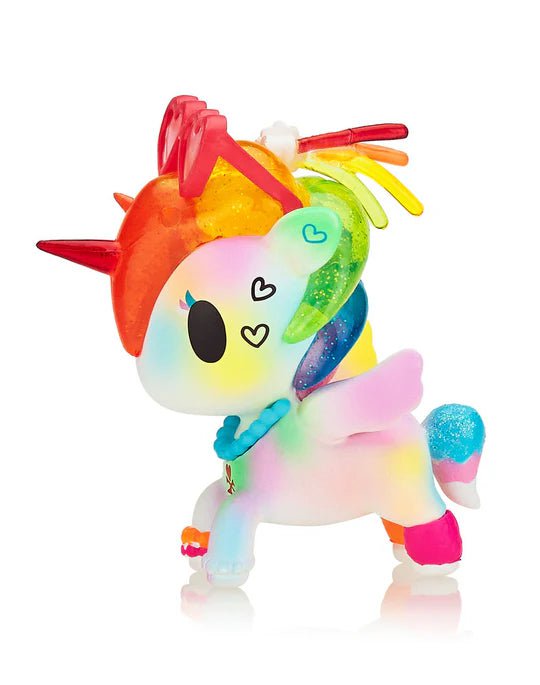 Tokidoki - Pride Lulu Special Edition Figure is a colorful unicorn toy with a rainbow mane, red horn, wings, and heart-shaped eye markings. It stands on four legs and features a holographic shine that adds an enchanting touch of sparkles.