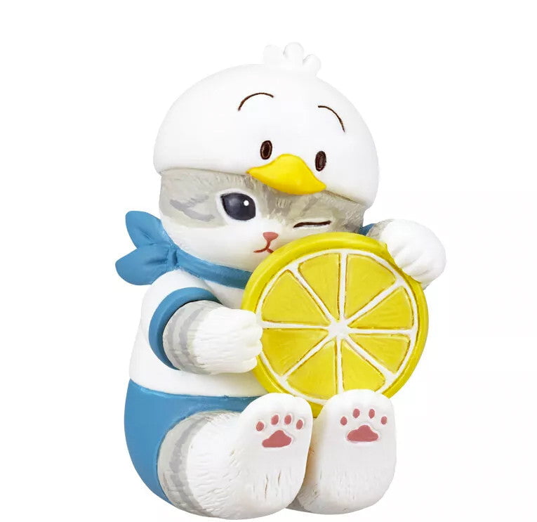 The Kitan Club (JP) Mofusand x Sanrio Series 2 Capsule-Set of 5 features a whimsical gray cat figurine in a duck costume holding a yellow lemon slice, perfectly capturing the playful Mofusand charm.