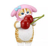 A small figurine from the Kitan Club (JP) Mofusand x Sanrio Series 2 Capsule-Set of 5, featuring a cat in a pink bonnet with a blue bow and cute kitties costume, holding two cherries, set against a white background.