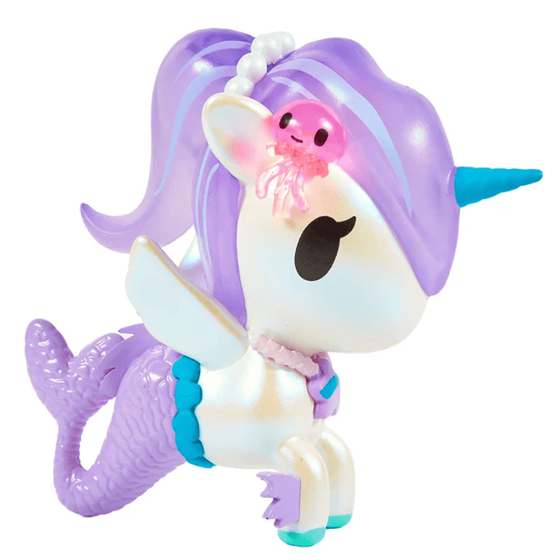Experience the enchanting charm of the Magical Tides Mermicorno Tokidoki by tokidoki—a toy featuring a unicorn horn, shimmering mermaid tail, delicate wings, and a flowing purple mane and tail. This pastel-colored figure captures ocean-inspired magic with its pearl necklace and a cute pink jellyfish perched atop its head—perfect for magical underwater adventures, just like the captivating characters from the Mermicorno Blind Box collection.