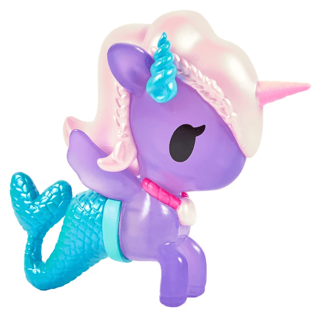 A playful and ocean-inspired figure, the Magical Tides Mermicorno Tokidoki by tokidoki features a purple body, unicorn horn, blue mermaid tail, pink mane, blue ears, shell necklace, and big black eyes—perfect for underwater adventures.