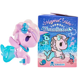 A pink and blue Magical Tides Mermicorno Tokidoki figurine, brimming with ocean-inspired charm, sits beside a vibrant box adorned with underwater-themed artwork and the tokidoki logo—an ideal collectible for fans of whimsical adventures and the beloved mermicorno blind box series.