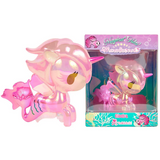A shiny pink Magical Tides Electra Mermicorno Special Edition toy with golden eyes is displayed next to its colorful box labeled “Electra” from tokidoki.