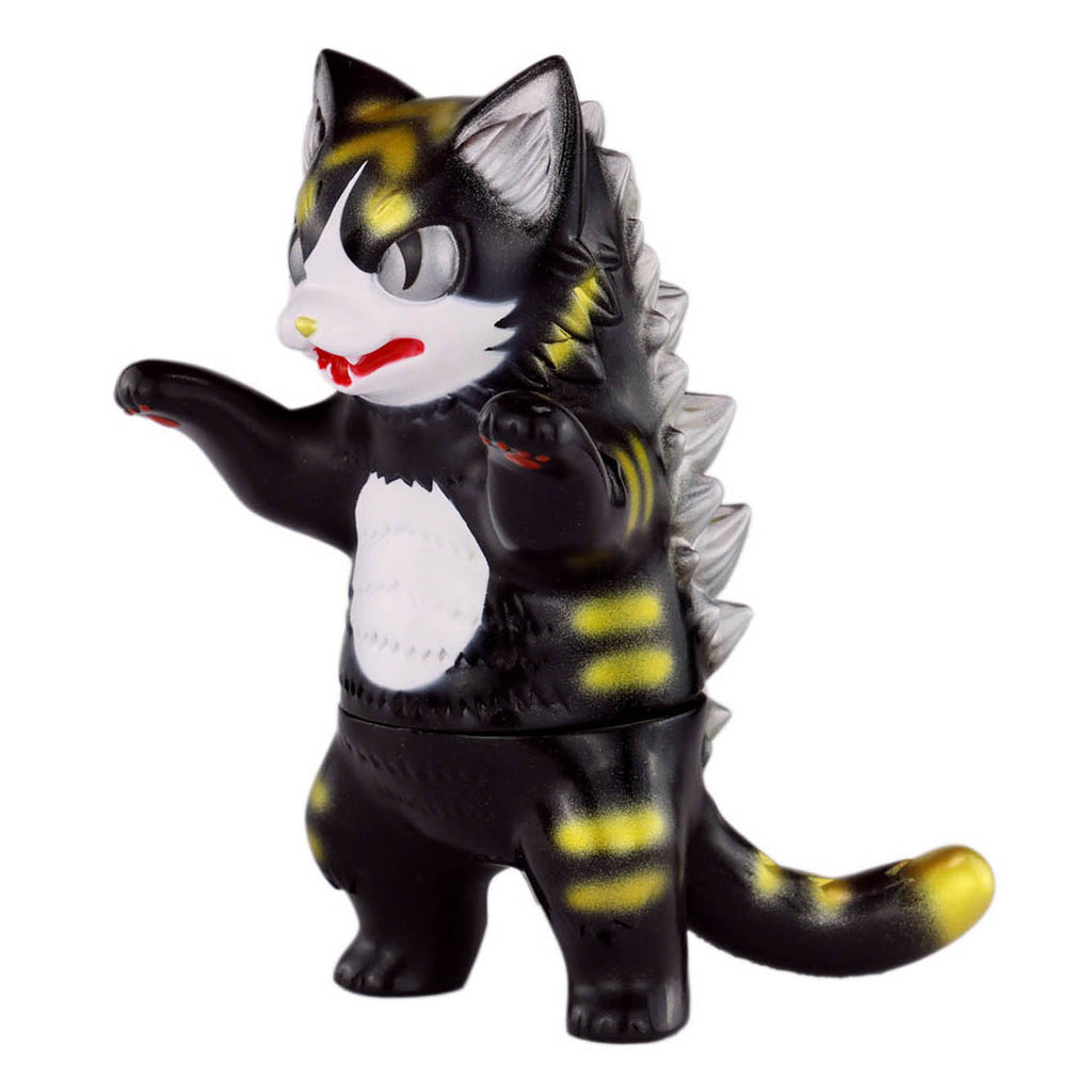 The Konatsuya (JP) Black Tiger Negora is a small, black and yellow figure with cat-like charm, featuring a dinosaur tail and spikes, standing upright with raised arms.