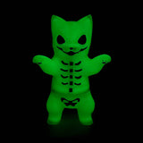 A neon purple glow Negora figurine from Konatsuya (JP), featuring skeletal markings, stands upright against a black background.