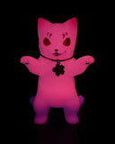 The Konatsuya Negora — Night Sakura is a glowing pink, glow-in-the-dark cat figurine with raised paws, a collar, and cherry blossom-shaped tag, shown against a black background.