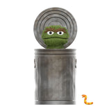 A grouchy green puppet with bushy eyebrows pops out of a trash can, accompanied by a small, smiling orange worm. This charming scene is perfect for fans of the Sesame Street Series 1 Super 7 Blind Box collectible toys by Super 7 (US).