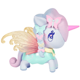 A pastel-colored Pixie Dust Fairy Unicorno Blind Box toy by tokidoki is shown from the back, featuring butterfly decorations, glittery golden wings, and a braided mane. The unicorn has a pink horn and wears a green and yellow outfit, making it a magical addition to any tokidoki collectible toys collection.