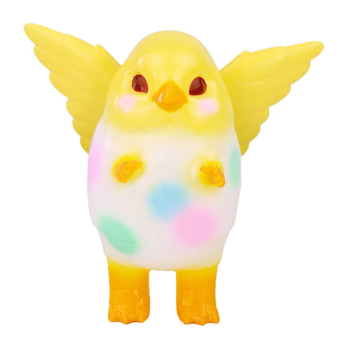 Pigora — Easter Egg by Konatsuya (JP) is a yellow-winged, bird-like toy inspired by the kaiju Pigora, featuring pastel spots on its white body. The figure stands upright against a white background.