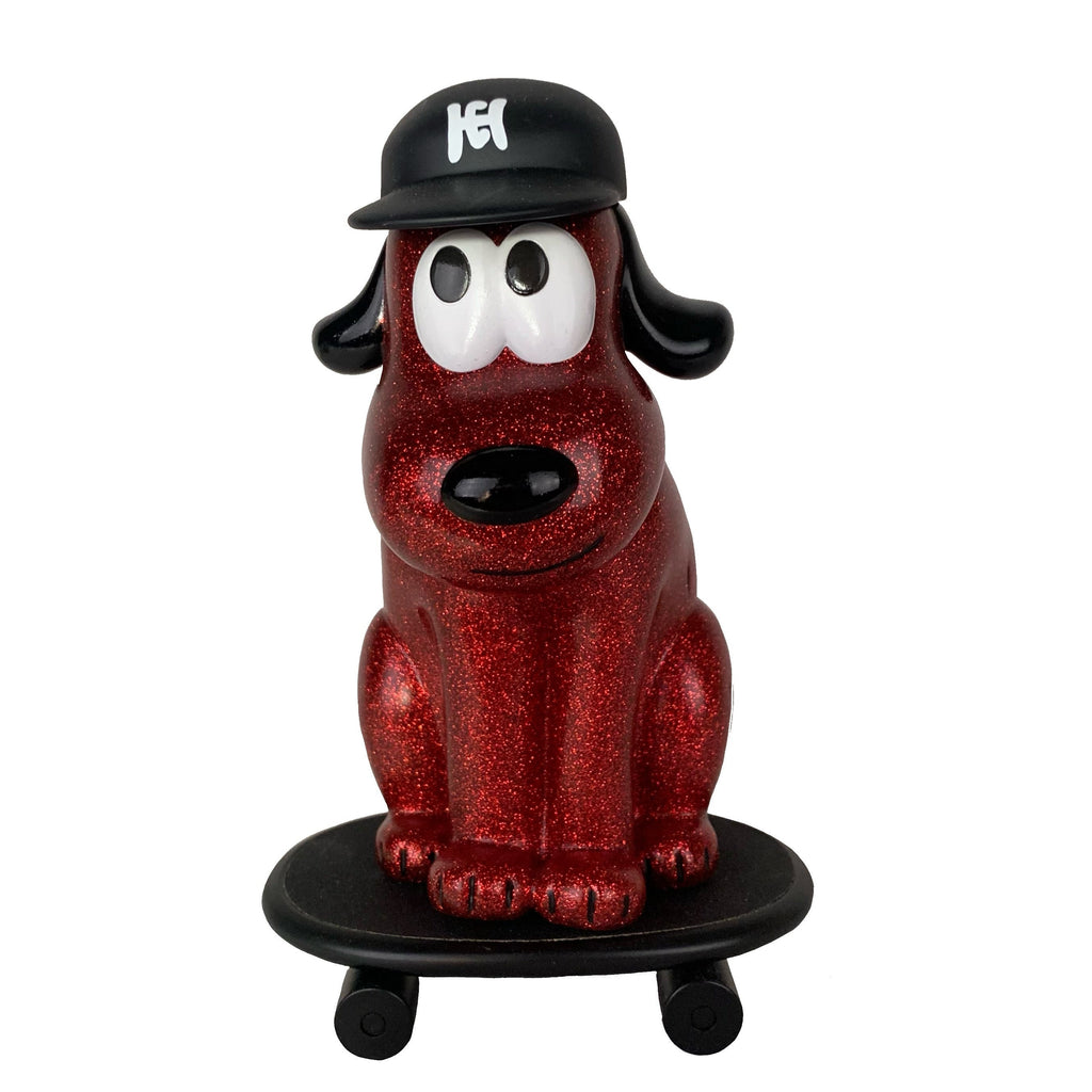 The How 2 Work One-Chu Sk8 - Red Glitter features a red glittery One Chu dog in a black cap sitting on an 8-inch collectible red glitter skateboard with four wheels, shown against a white background.