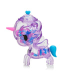 The Tokidoki Sugar Shop Unicorno - Very Berry (Special Edition) is a purple translucent unicorn figurine featuring a pink horn, blue tail, wings, colorful beads inside, and a heart-shaped detail on top. It's truly enchanting.