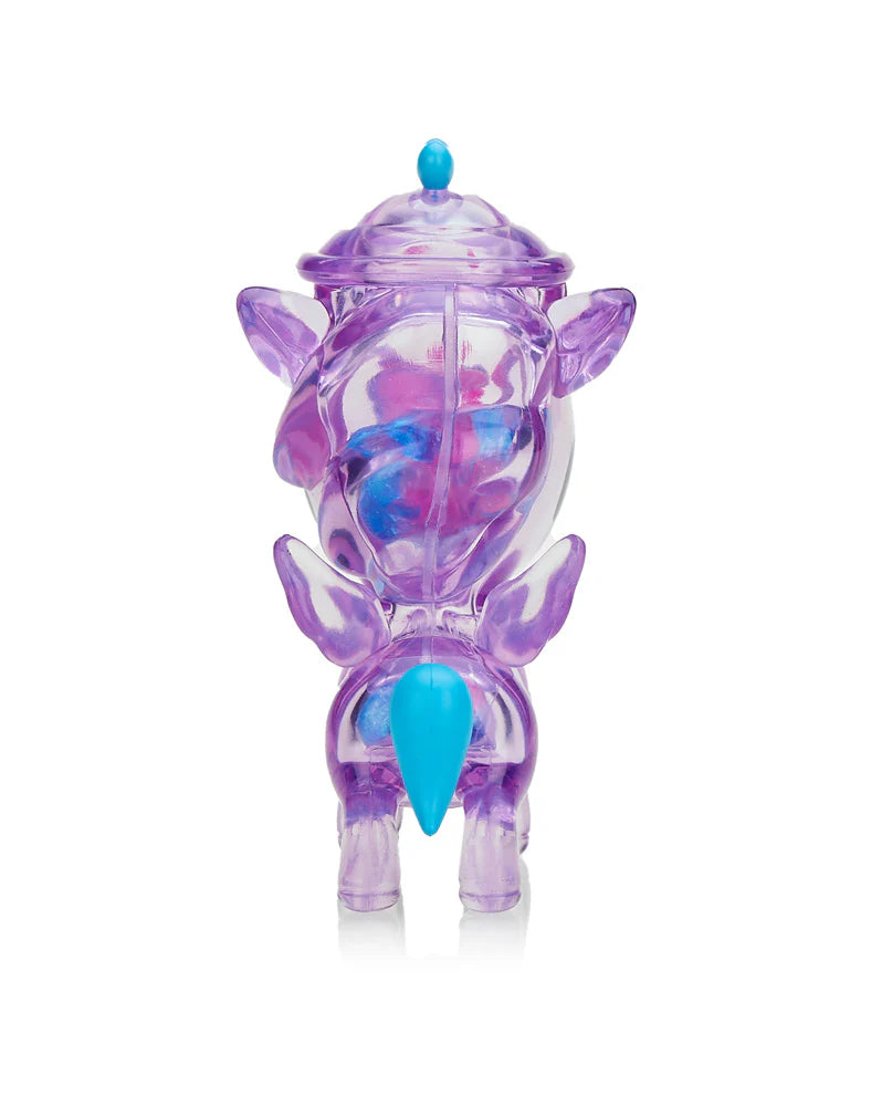 Introducing the Tokidoki Sugar Shop Unicorno - Very Berry (Special Edition): a translucent purple figurine with a small lid, dazzling wings, and a striking blue tail, perfect for adding enchantment to any display.