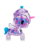 The Tokidoki Sugar Shop Unicorno - Very Berry (Special Edition) flaunts a purple transparent body, pink horn, blue tail, wing details, and is adorned with blue and pink bead-like decorations.