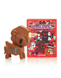 A small wooden toy with a tokidoki After Dark unicorno Series 4 - Blind Box in front of it.