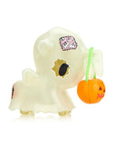 A tokidoki After Dark unicorno Series 4 - Blind Box with a pumpkin in its mouth.