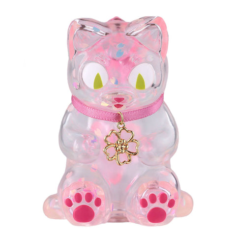 Sitting Negora — Falling Sakura by Konatsuya (JP): a clear pink cat figurine with a pink collar, gold flower charm, large green eyes, and pink paw pads.