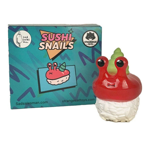 A toy figure from the Rotofugi Sushi Snails Blind Box, shaped like a snail with a sushi body, stands before its vibrant packaging—ideal for collectors and fans of unique designer toys.