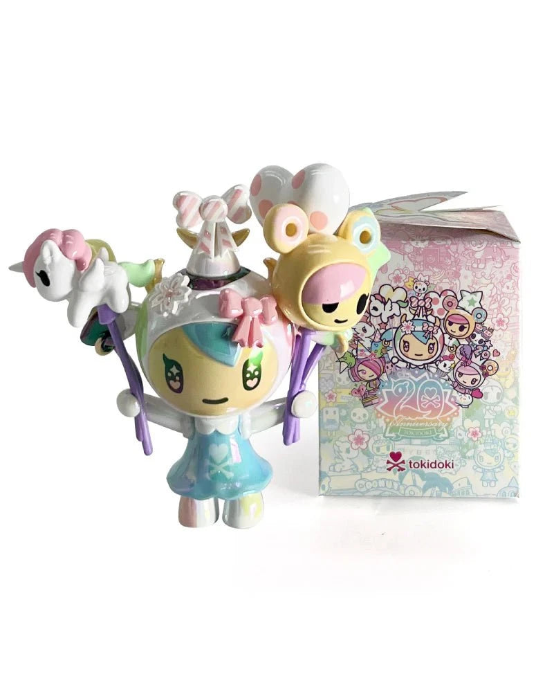 The tokidoki (IT) 20th Anniversary Blind Box features a pastel vinyl figurine with balloons and animal accessories, displayed before a matching decorated box—ideal for kawaii collectors and tokidoki fans.