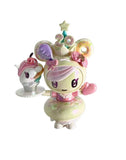 A pastel-toned figurine with donut hair, holding a dessert plate with a swan treat and 