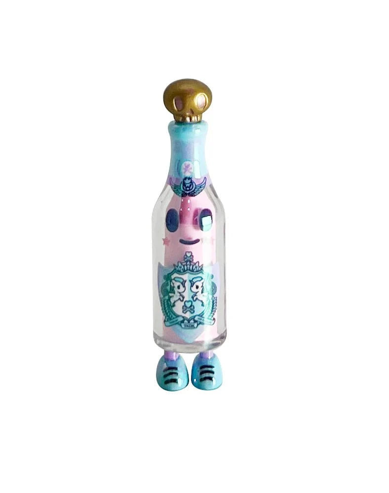 The tokidoki (IT) 20th Anniversary Blind Box features a clear bottle with cartoon eyes, mouth, and feet, teal accents, and a gold cap—an adorable collectible perfect for kawaii fans and celebrating tokidoki’s milestone!.