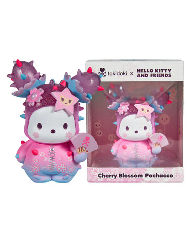 The Tokidoki x Hello Kitty and Friends - Cherry Blossom Pochacco vinyl collectible by Rotofugi stands by its box, featuring pink, purple, and blue hues with star and flower details.
