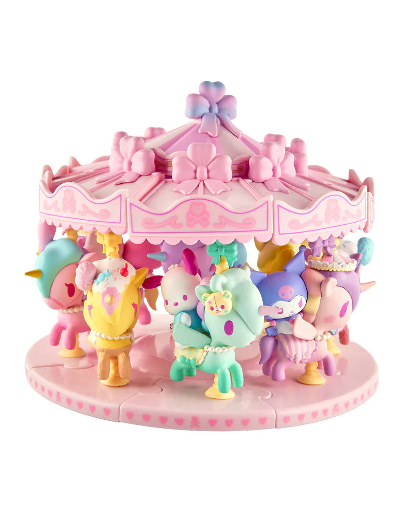 The tokidoki x Hello Kitty and Friends Sweet Pink Carousel Blind Box by tokidoki features collectible Sanrio figures riding horses, decorated in pastel pink, purple, and yellow.