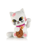 A collectible kitty figurine from the tokidoki (IT) Tokidoki Lucky Cats Blind Box, featuring a waving cat with pink flower patterns, yellow eyes, a purple collar with a bell, and a brown oval coin with a flower design.