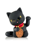 The tokidoki (IT) Tokidoki Lucky Cats Blind Box features a black collectible maneki-neko figurine with yellow eyes, a red collar, a gold coin, and an upraised left paw, displayed on a white background.