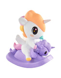 The Tokidoki Baby Unicorno Blind Box by tokidoki features a small pastel figurine with an orange mane riding a purple rocking horse—a charming collectible surprise in every box.