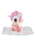 The Tokidoki Baby Unicorno Blind Box by tokidoki features an adorable figurine with pink hair holding a plush pink bunny—an irresistible choice for any collectible figure enthusiast.