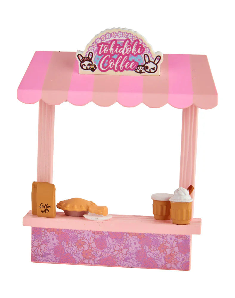 The tokidoki Farmers Market Unicorno - Cafe Cuties Coffee Bar (Special Edition) is a small pink and white toy coffee stand with 